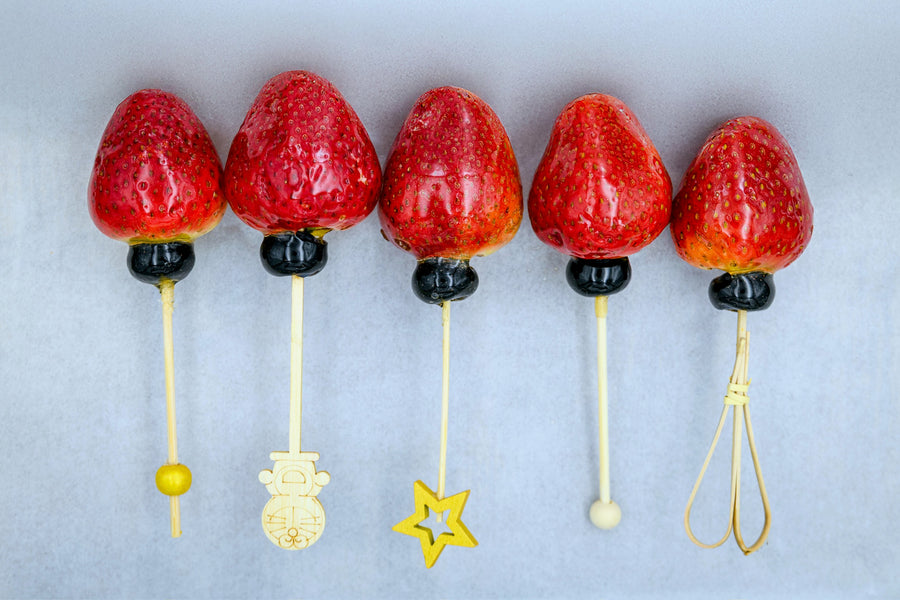 Fresh strawberry tanghulu skewer with crystal sugar glaze